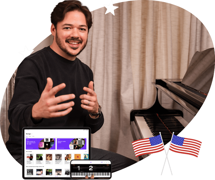 Playground Sessions teacher Phil Anderson waves for you to join him at the piano behind him. A tablet and phone running the Playground Sessions piano learning app are shown toward the bottom.